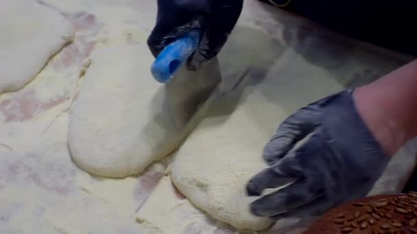 Cooking. The cook works with raw dough in the kitchen. Close-up — Stock Video