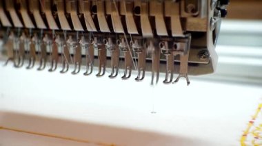 Tekstil endüstrisi. Teknolojik süreç. Modern endüstriyel nakış makinesi imalata model uyguluyor. Yakın çekim.