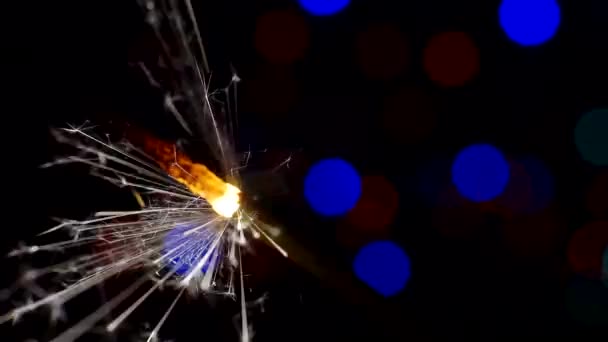 Ünnepi háttér. Újév és karácsony.égő csillag.Bengáli gyertya világít fényesen hátterében fényes bokeh körök.Közelkép. — Stock videók
