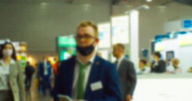 İş teması geçmişi. Büyük ve parlak bir iş merkezinde tanınmayan insanlar. Bulanık odaklı görüntü