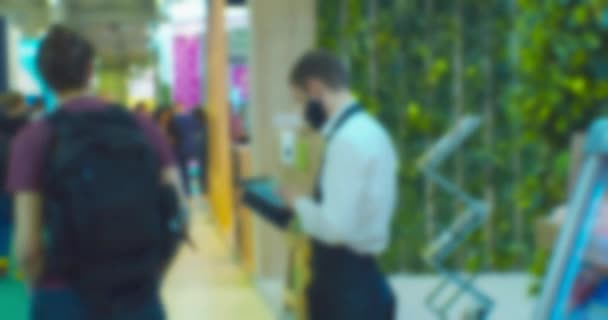 Blurred silhouette of an unrecognizable person with an electronic tablet in his hands.Defocused video.Business background — Video