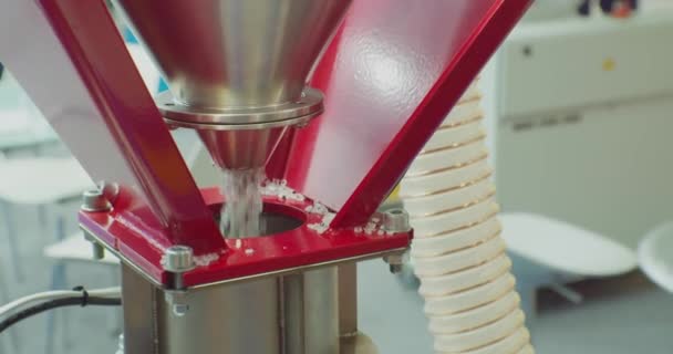Modern production. processing and production of plastic. round gray plastic pellets fall out of the hopper.close-up. shallow depth of field — Stock Video