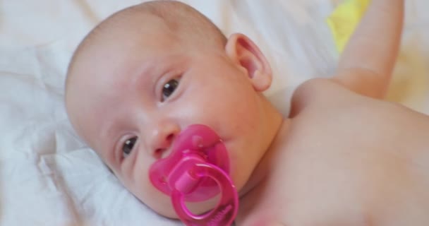 Cute baby infant lying in bed. portrait. close-up — Stock Video