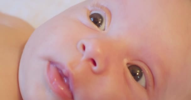 Curious surprised look of a little cute baby.close-up — Stock Video