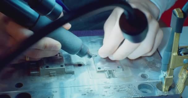 Modern technology. male hands hold a soldering iron and solder the wire to the part.close-up — Stock Video