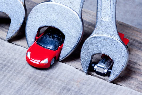 Little toy car and wrenches — Stock Photo, Image