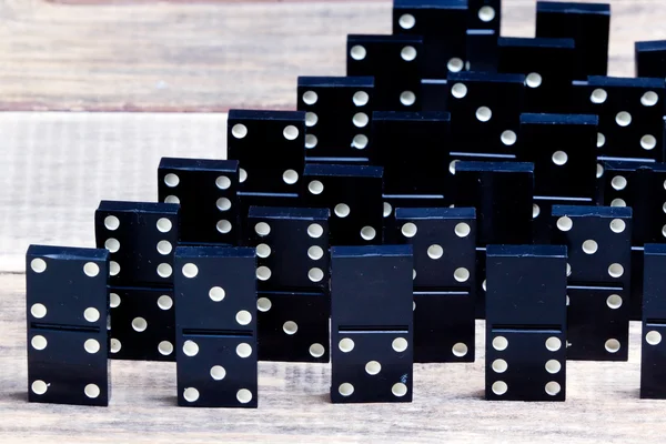 Old dominoes lies on a wooden surface — Stock Photo, Image