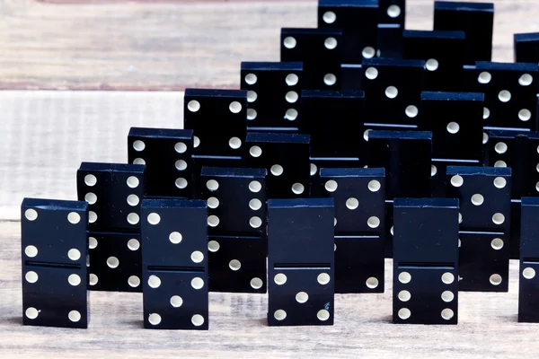 Black Dominoes game block in a row on a colored background Stock Photo -  Alamy