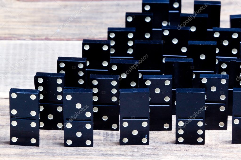 old dominoes lies on a wooden surface