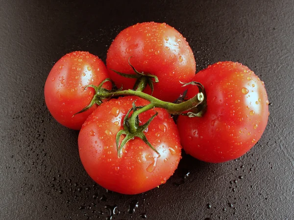 Tomates en gotas sobre fondo negro —  Fotos de Stock