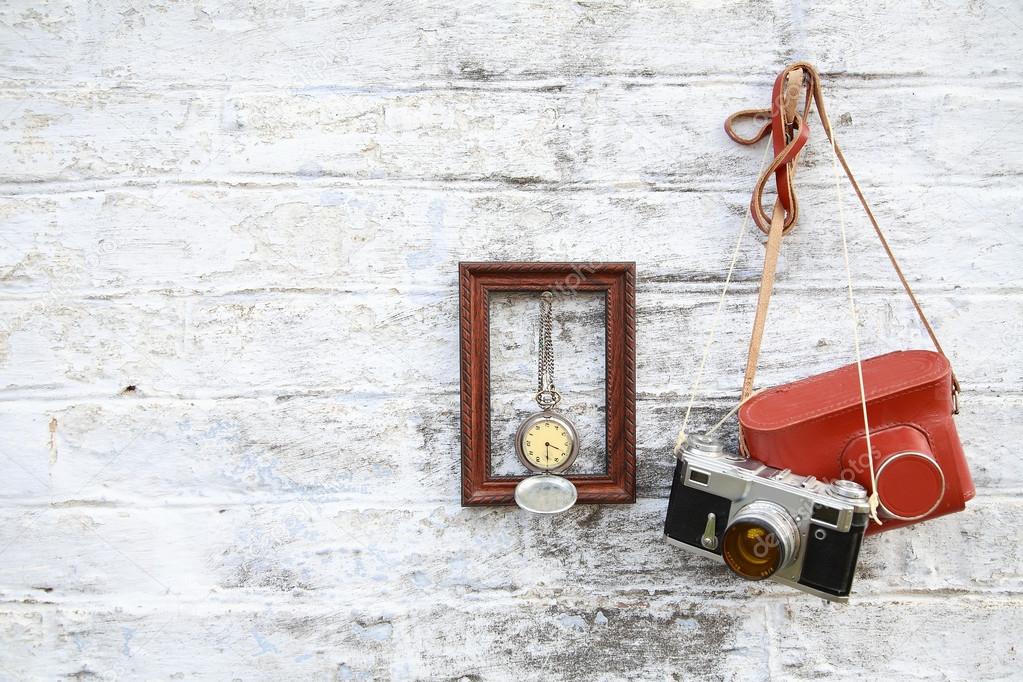 Old camera with a frame hanging on the wall