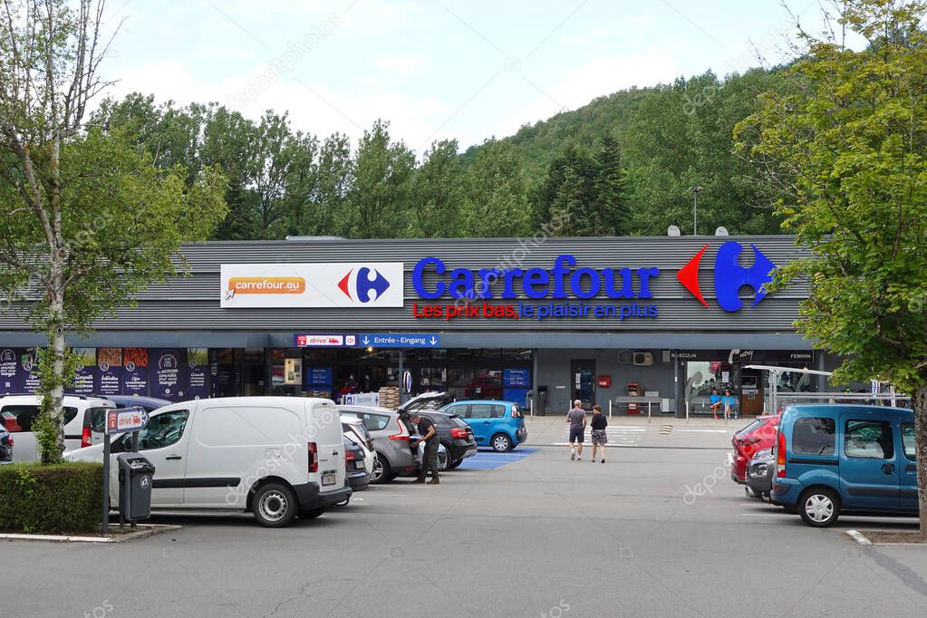MALMEDY, BELGIUM - MAY 2015: Entrance and parking lot of a Carrefour hypermarket. Carrefour is a French multinational retailer and one of the largest hypermarket chains in the world.