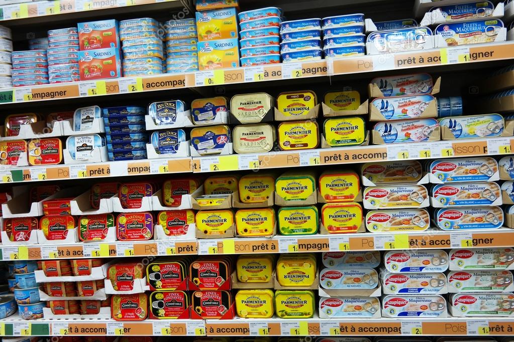 FRANCE - JULY 2014:  Shelves filled with tin cans of fish in a Leclerc supermarket