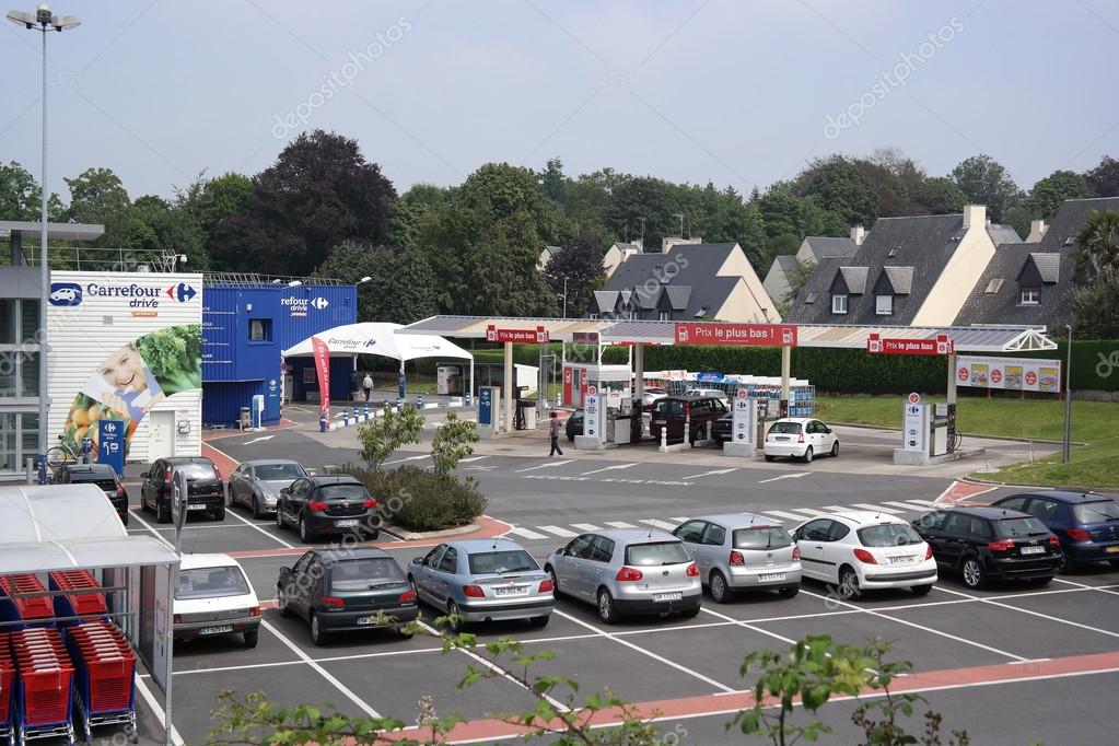 SAINT-LO, FRANCE - JULY 2014: Carrefour supermarkets in Europe have branched into petrol retailing, as shown by this filling station beside a hypermarket in Normandy, France