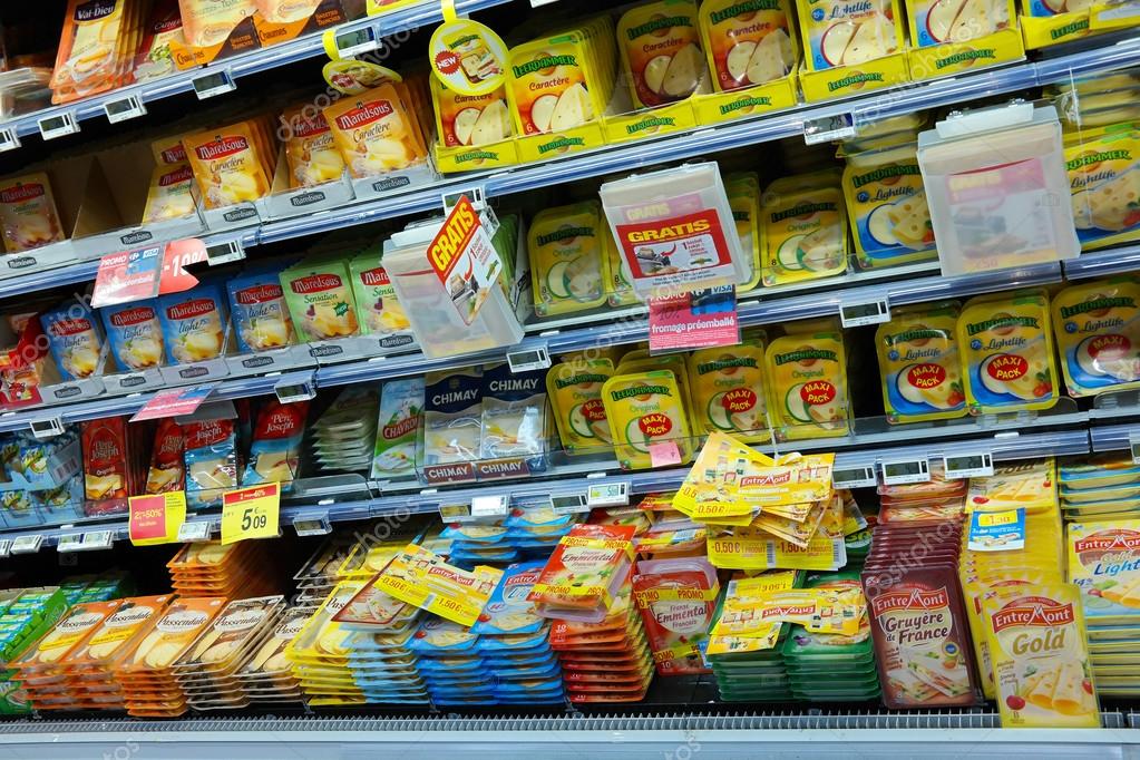 WALLONIA, BELGIUM - OCTOBER 2014: Refrigerated shelves with a variety of sliced cheese packages at a Carrefour Hypermarket