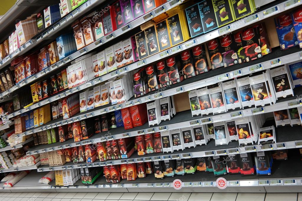 NORMANDY, FRANCE - JULI 2014: Shelves with a variety of chocolate products in a Carrefour Hypermarket in France