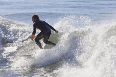Kaliforniya'da Santa Cruz plajda sörf atlet