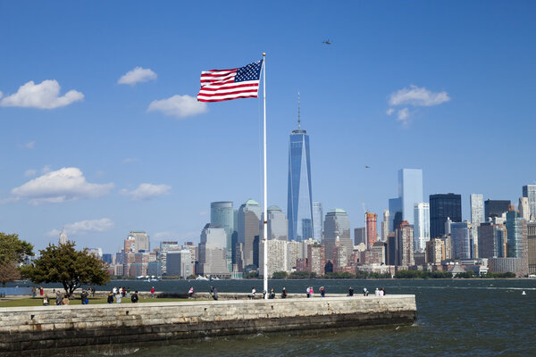 New York City, USA - October 6, 2014: New York panorama, One World Trade Center (formerly known as the Freedom Tower) and Ellis Island. Freedom Tower is shown finished with antenna.