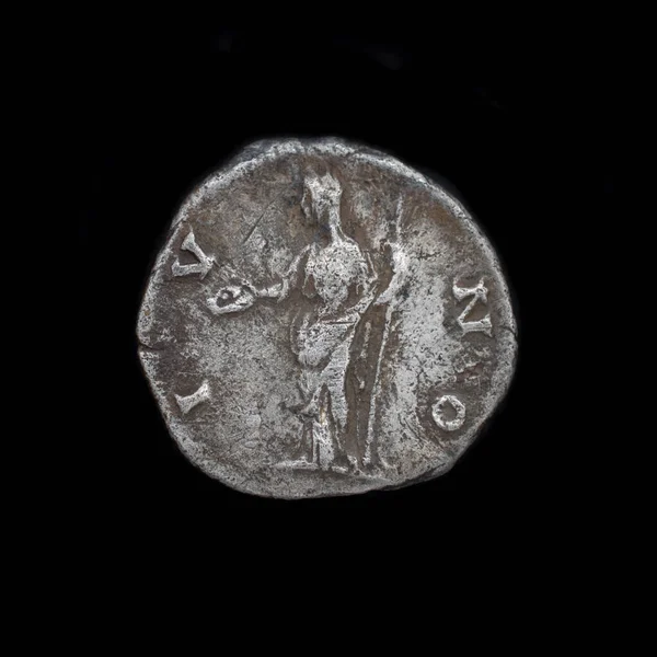 Roman silver denarius isolated on black background. Ancient roman silver coin. Faustina II silver denarius 175 AD. Roman silver coin found with metal detector.