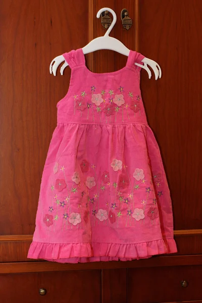 A little girl dress hanging in a children clothing store. — Stock Photo, Image