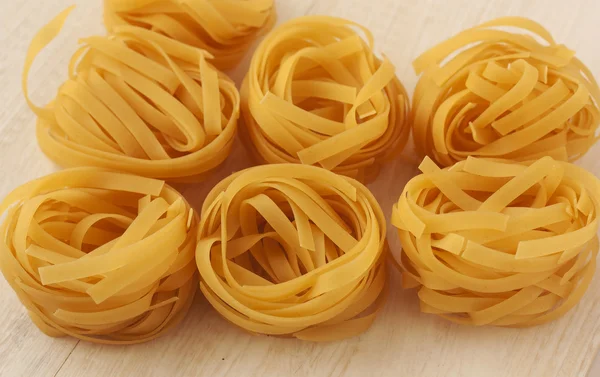 Italian rolled fresh fettuccine pasta. — Stock Photo, Image