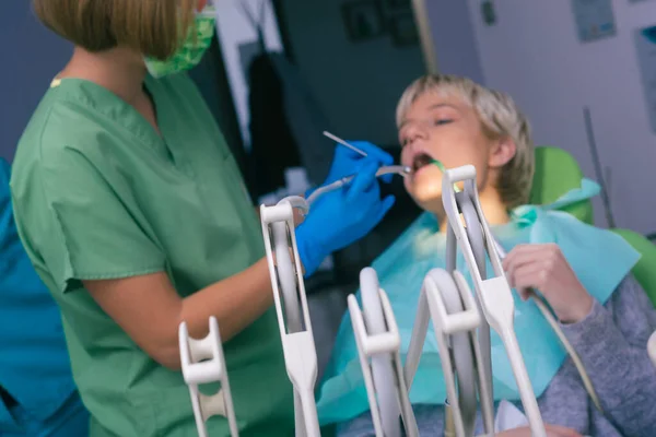 Female dentist examining a female patient with modern equipment