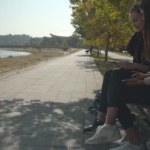 Friends sitting together on a bench in the park