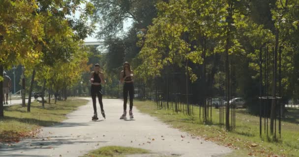 Young Girls Rollerblading Together Park — Stock Video