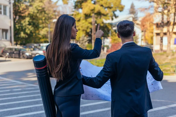 Backview Suited Male Female Architects Looking Together Building Blueprint — Stock Photo, Image