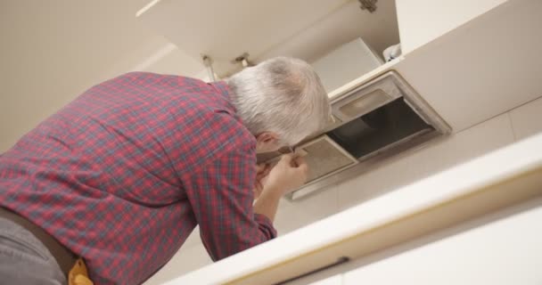Senior Handyman Fixing Household Appliances Apartment — Stock Video