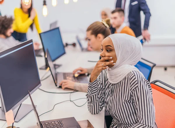 Şaşırmış Afrikalı Müslüman Kadın Birden Fazla Bilgisayarda Ortak Çalışma Alanında — Stok fotoğraf