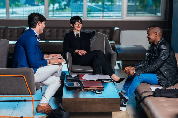Τρεις Πολυεθνικοί Επιχειρηματίες Που Πραγματοποιούν Συνάντηση Σύγχρονο Γραφείο — Φωτογραφία Αρχείου