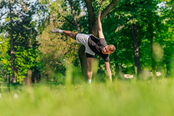 Attractive Caucasian Young Man Stretching Doing Yoga Exercises Green Grass — Stock Photo, Image