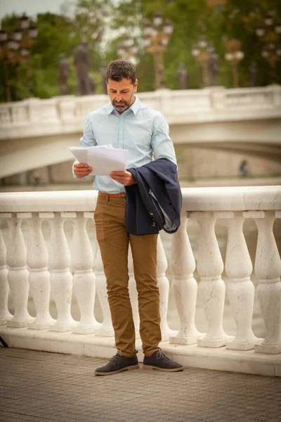 Αστικός Επιχειρηματίας Στέκεται Και Κοιτάζει Έγγραφα — Φωτογραφία Αρχείου