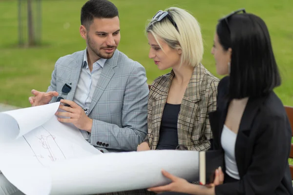 Three Casual Dressed Business People Working Blueprints — ストック写真