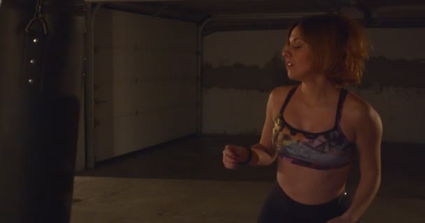 Strong Red Hair Girl Kicking Punching Bag While Practicing — Stock Video