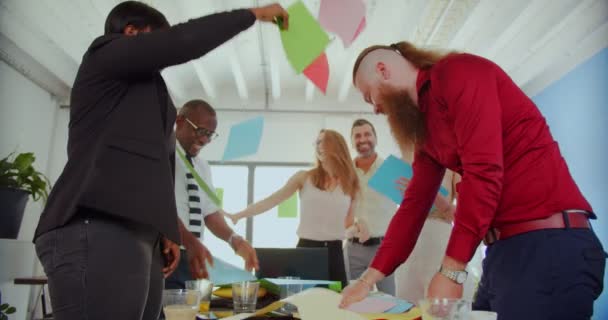 Multiracial Business Partners Celebrating Success While Throwing Colored Sheets Air — Stock Video