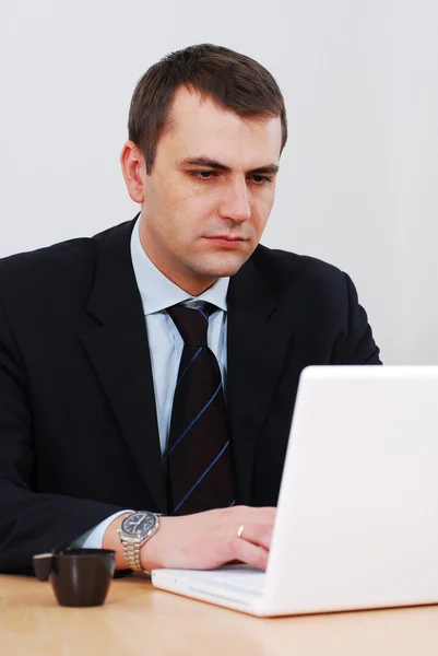 Seriöser Geschäftsmann arbeitet an Laptop — Stockfoto