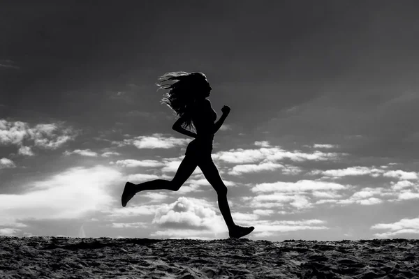 Silhouette of a girl runner effect films — Stock Photo, Image