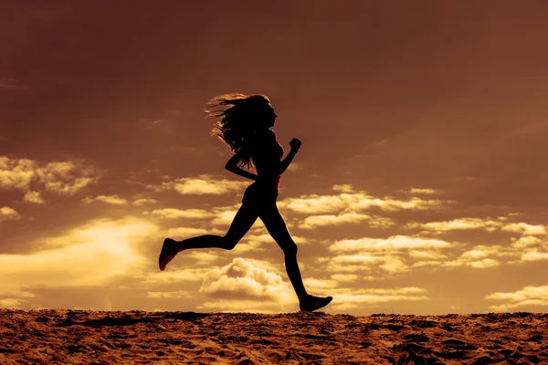 Silhouette of a girl runner effect films — Stock Photo, Image