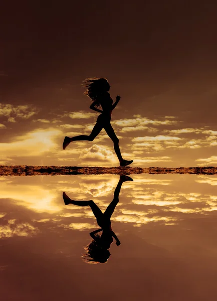 Female runner silhouette — Stock Photo, Image