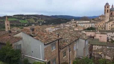 Panoramic view of the city of Urbino, Italy. Ancient italian renaissance city, Unesco world heritage site. Houses, palaces, cathedrals and towers of the Doge's Palace under a cloudy sky