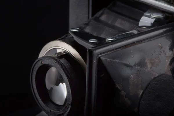 Old vintage camera on black background. — Stock Photo, Image