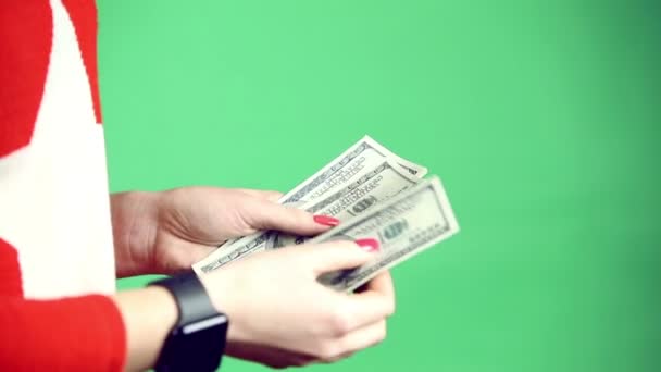 Girls hands playing with money on green background — Stock Video