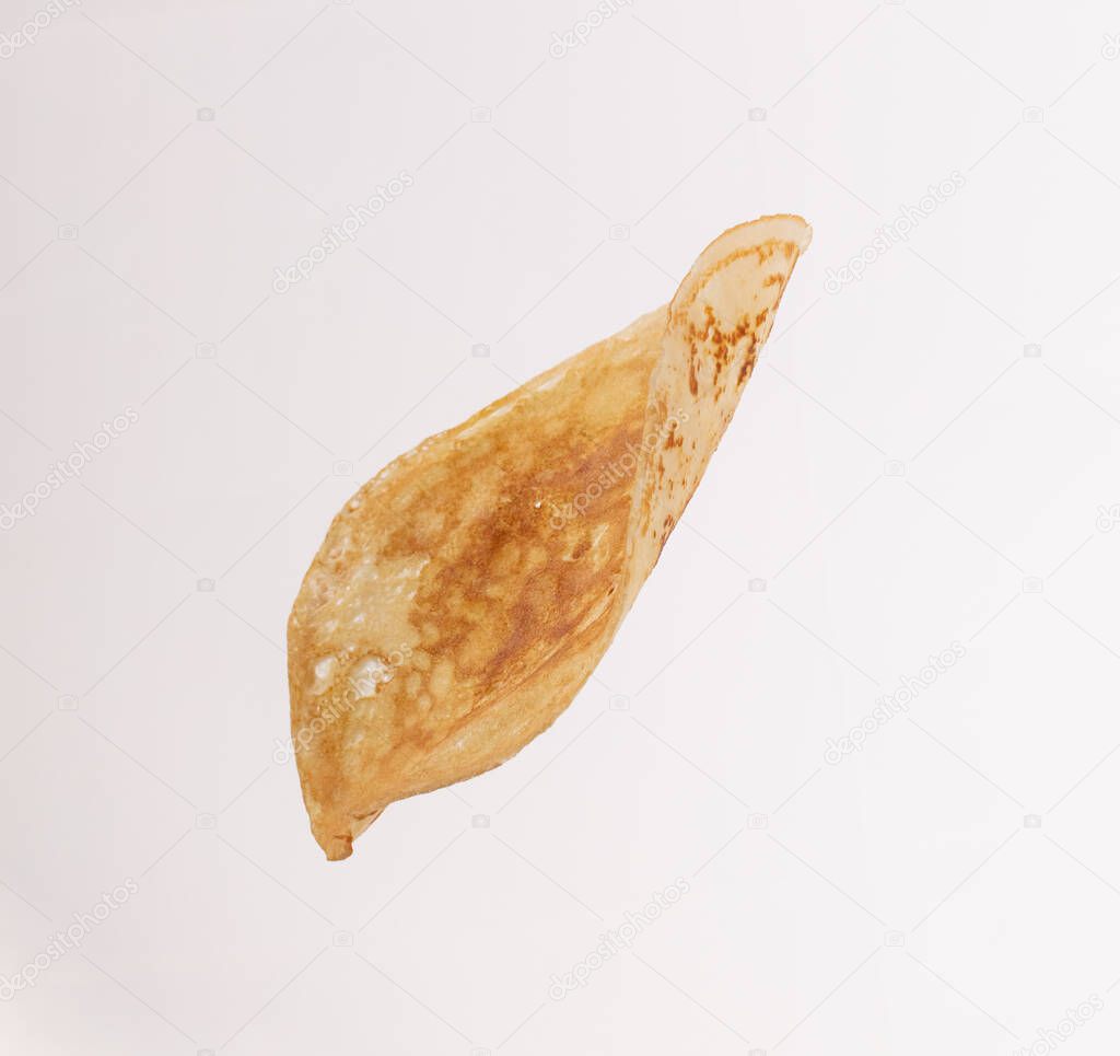 Thin pancake isolated on white backgroundFalling thin pancake in the air.Food levitation