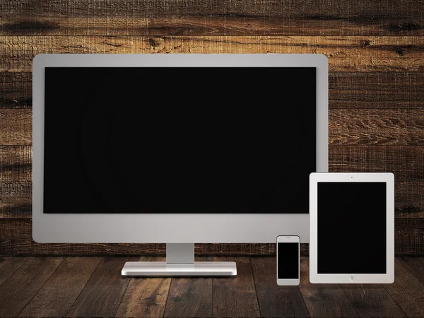 Monitor tablet and phone on old wood surface. — Stock Photo, Image