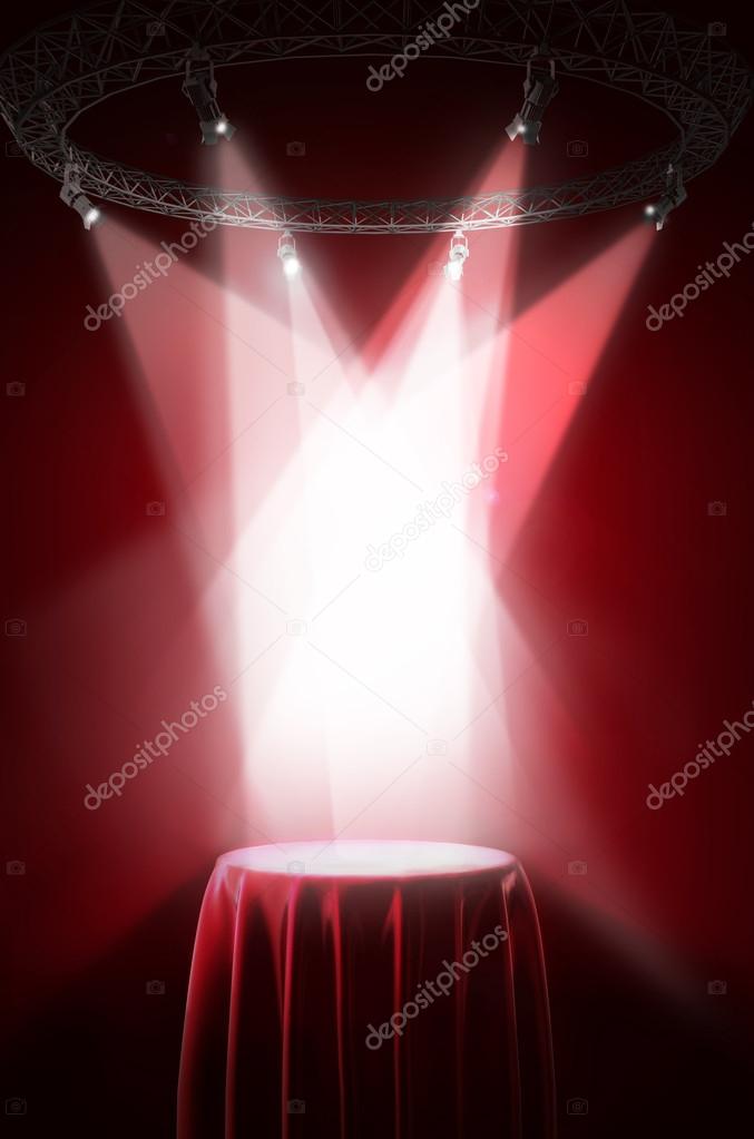 Presentation pedestal covered with red silk cloth on a red background.