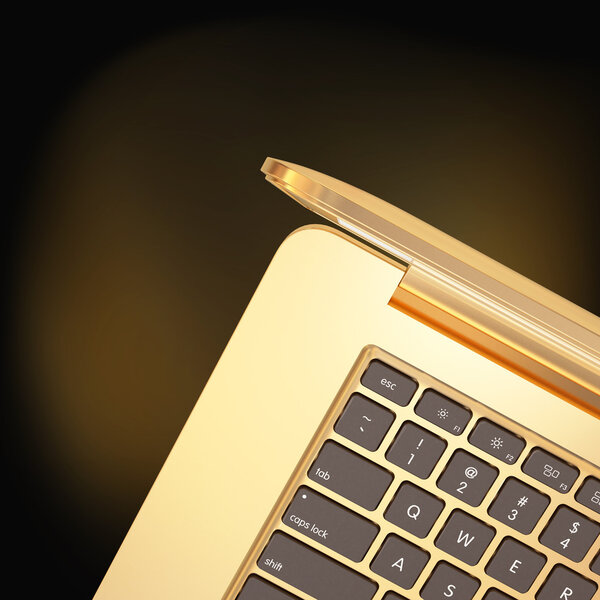 Golden laptop on a black  background 