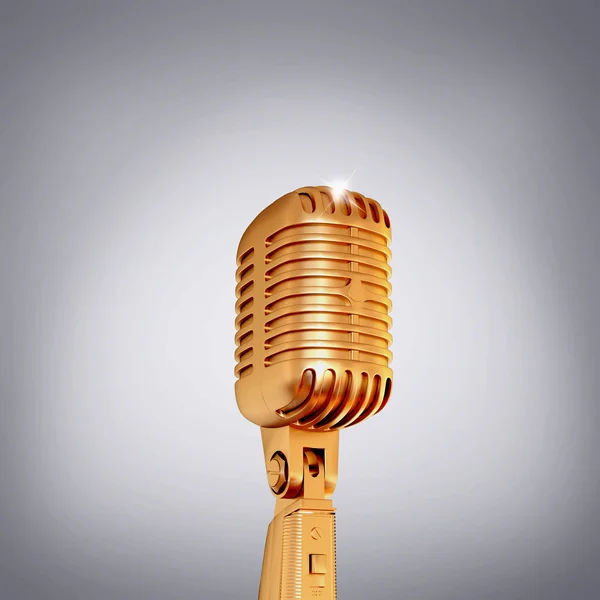 Micrófono retro dorado sobre fondo gris . — Foto de Stock