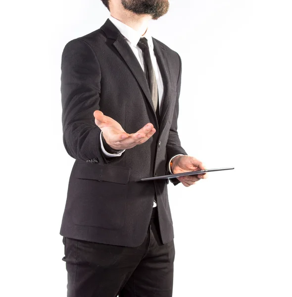 Hipster homme en costume classique isolé sur fond blanc avec une tablette à la main — Photo